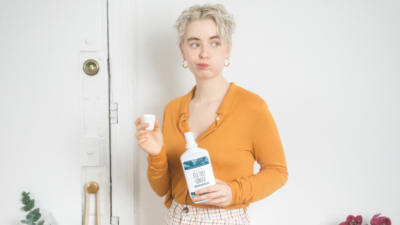 Girl swishing with Schmidt's Tea Tree+Ginger Mouthwash